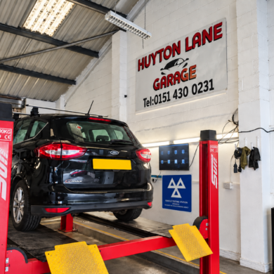 Car on a ramp in the MOT bay at Huyton Lane Garage, Huyton